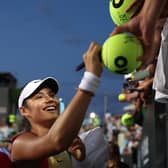 Emma Raducanu signs autographs after she won her first round match at the Australian Open.