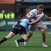 Edinburgh man of the match Jamie Ritchie is tackled by Ciaran Parker of Cardiff. Pic: Kian Abdullah/Huw Evans/Shutterstock (14452694y)