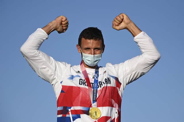 Great Britain's Giles Scott celebrates on the podium after his Finn class gold medal. Picture: AFP via Getty Images