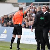 Ross County manager Malky Mackay is shown a yellow card during the match against Celtic.