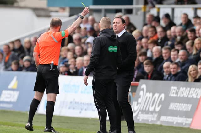 Ross County manager Malky Mackay is shown a yellow card during the match against Celtic.