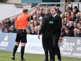 Ross County manager Malky Mackay is shown a yellow card during the match against Celtic.