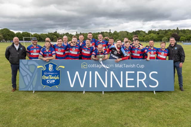 The victorious KIngussie team recieve the MacTavish Cup from the sponsors cottages.com.