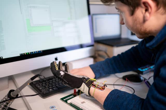 Engineering graduate Ross O'Hanlon hopes to aid millions of people after helping create the glove which uses artificial intelligence to boost muscle grip.