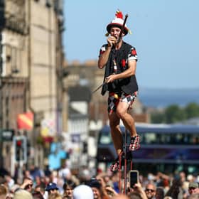 A juggling Fringe street artiste eats a potato mid-performance on Edinburgh's Royal Mile (Picture: Jeff J Mitchell/Getty Images)