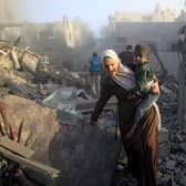 People flee following Israeli air strikes on a neighbourhood in the al-Maghazi refugee camp in the central Gaza Strip. Picture: Yasser Qudih/AFP via Getty Images