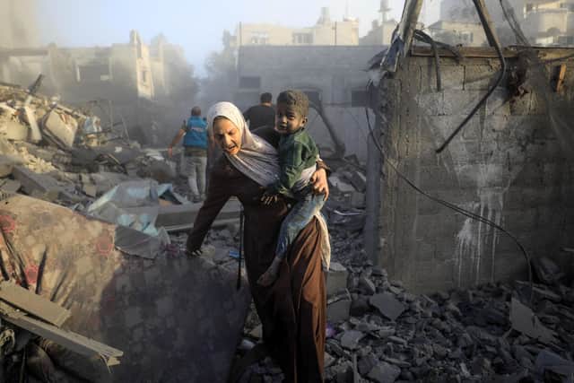 People flee following Israeli air strikes on a neighbourhood in the al-Maghazi refugee camp in the central Gaza Strip. Picture: Yasser Qudih/AFP via Getty Images