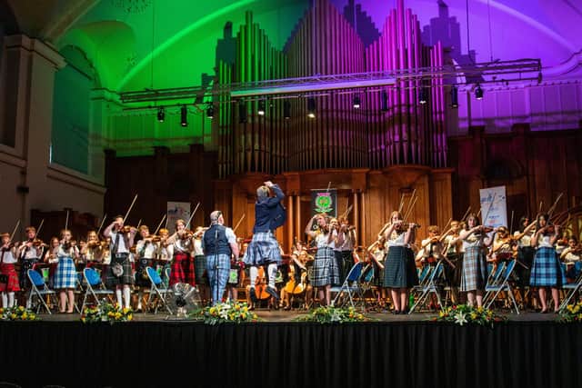 The Ayrshire Fiddle Orchestra performing with some members wearing the World Peace Tartan designed by Victor Spence (pic: Brian Muir)