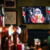 Customers in The Scotsman's Lounge in central Edinburgh watch the televised  State Funeral Service