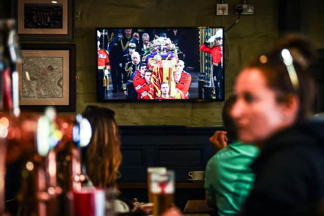 Customers in The Scotsman's Lounge in central Edinburgh watch the televised  State Funeral Service