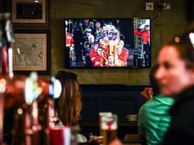 Customers in The Scotsman's Lounge in central Edinburgh watch the televised  State Funeral Service