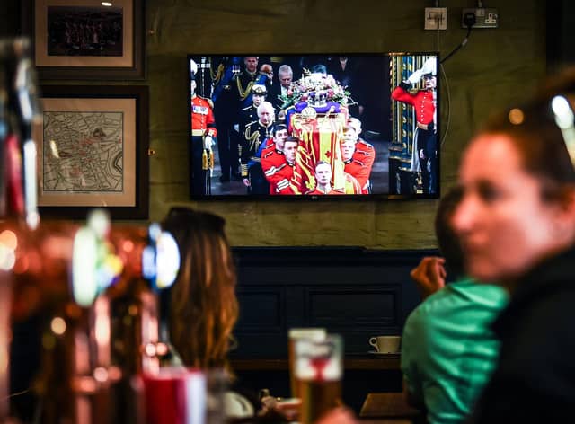 Customers in The Scotsman's Lounge in central Edinburgh watch the televised  State Funeral Service