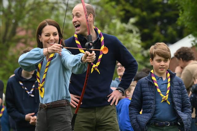Watched by Prince William, the Prince and Princess of Wales try archery at the 3rd Upton Scouts in May last year (Picture: Daniel Leal/pool/AFP via Getty Images)