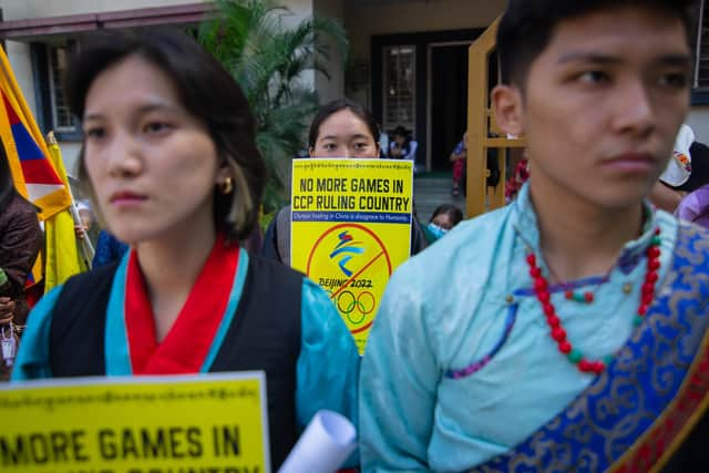 Tibetan students hold up placards calling for the boycott of the 2022 Beijing Winter Olympics during a protest in Bengaluru, India (Picture: Abhishek Chinnappa/Getty Images)