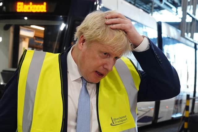 Boris Johnson gestures as he speaks to members of the media during a visit to the Blackpool Transport Depot