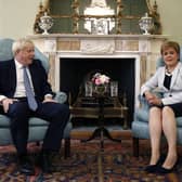 Scotland's First Minister Nicola Sturgeon, right, sits with Britain's Prime Minister Boris Johnson, in Bute House. Mr Johnson has inflamed Scottish discontent with his Conservative government by reportedly saying that giving governing powers to Scotland had been a "disaster". Picture: Duncan McGlynn/Poo Photo via AP, File