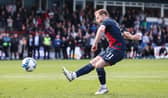 Josh Sims scores the winning penalty for Ross County in the Premiership play-off final.  (Photo by Craig Williamson / SNS Group)