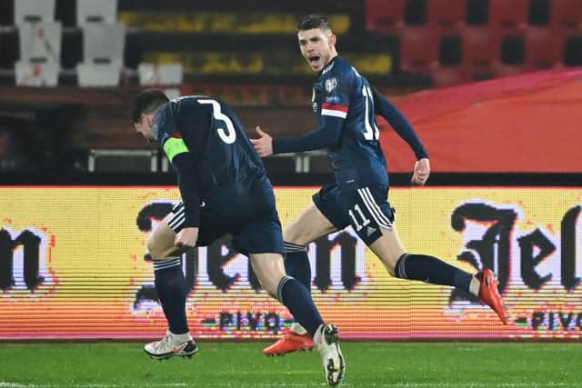Scotland forward Ryan Christie celebrates with Andrew Robertson in Serbia. (Photo by ANDREJ ISAKOVIC/AFP via Getty Images)