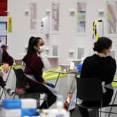 People carry out asymptomatic testing using lateral flow antigen at a test centre at Edinburgh University ahead of students being allowed to travel home for the Christmas holidays.