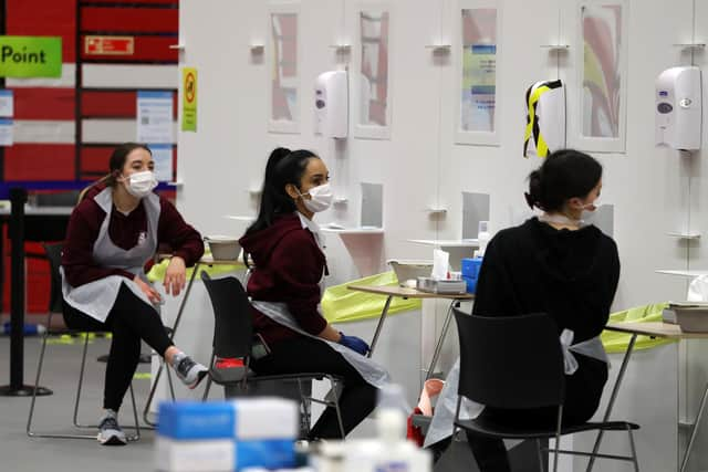 People carry out asymptomatic testing using lateral flow antigen at a test centre at Edinburgh University ahead of students being allowed to travel home for the Christmas holidays.