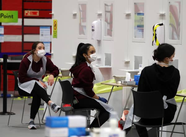 People carry out asymptomatic testing using lateral flow antigen at a test centre at Edinburgh University ahead of students being allowed to travel home for the Christmas holidays.