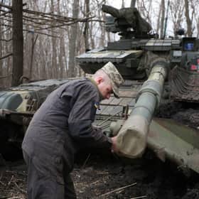 A Ukrainian serviceman works on his tank near the city of Lysychansk, not far from the front line with Russian-backed separatists earlier this month (Picture: AFP via Getty Images)
