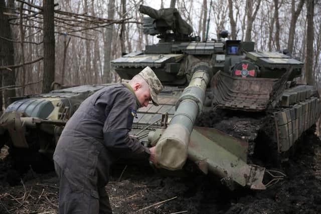 A Ukrainian serviceman works on his tank near the city of Lysychansk, not far from the front line with Russian-backed separatists earlier this month (Picture: AFP via Getty Images)