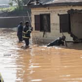 Fire fighters inspect damages caused by heavy rain which led to flood homes in Addis Ababa, Ethiopia.