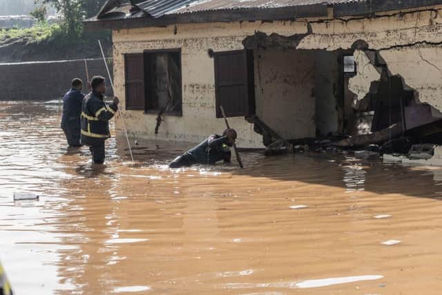 Fire fighters inspect damages caused by heavy rain which led to flood homes in Addis Ababa, Ethiopia.