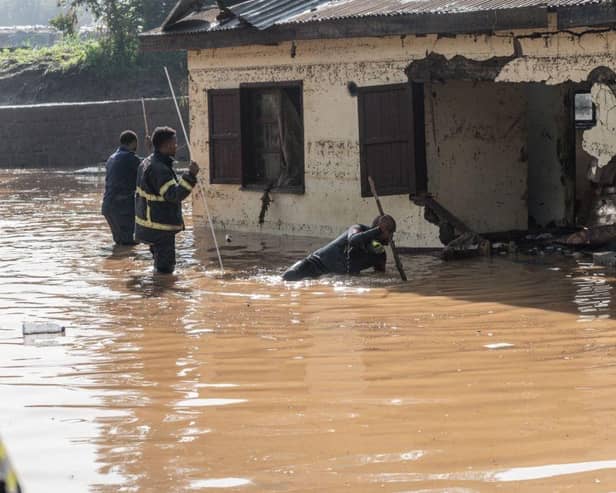 Fire fighters inspect damages caused by heavy rain which led to flood homes in Addis Ababa, Ethiopia.