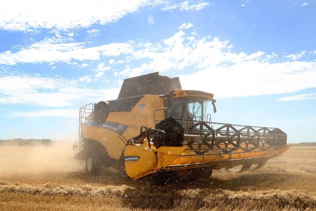 A combine harvester cutting a crop of spring barley in a field. Picture: Gareth Fuller/PA Wire