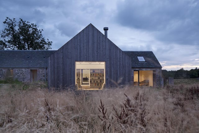 This new house is located within and around a ruined building in the Ayrshire landscape – formed over two hundred years to house people and cattle. Ann Nisbet Studio conceived the project as a ‘building within a ruin’ – taking a quiet, honest and restrained approach that brings the building gently back to life as a home while retaining the character of the ruin. In the wrong hands, the ruin could have been over-domesticated or romanticised: instead it retains its character and relationship to the landscape, thanks to a light-touch and respectful approach, as well as a careful use of materials. A simple timber-clad second building, connected to the ruin by a glazed link, provides additional space.