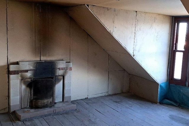 This Victorian attic flat has some original fittings including a porcelain sink and scraps of floral wallpaper. It has no gas connection but does have electricity and running water, and is in a mansion-style fronted house with views over Rothesay Bay.