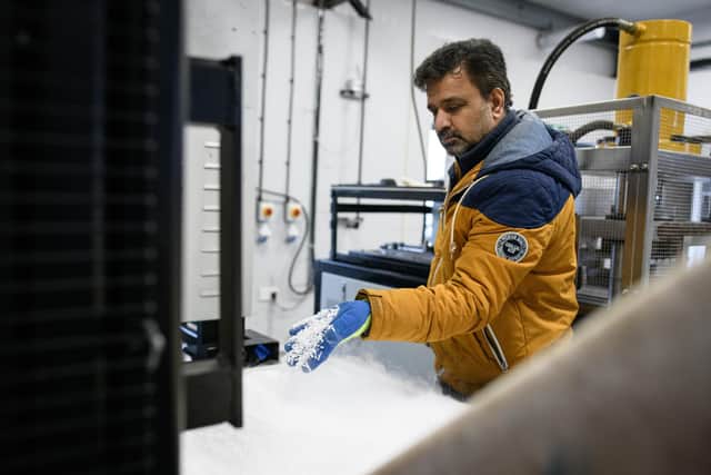 Managing director Nilesh Acharya handles a fresh production of fine dry ice pellets at the Dry Ice Nationwide manufacturing facility in Reading. The Pfizer/BioNTech vaccine must be kept at ultra-cold temperatures during its journey from the production line to a patient's arm (Picture: Leon Neal/Getty Images)