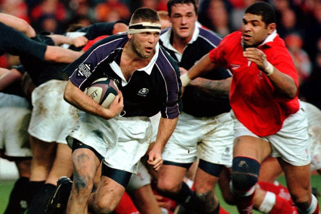 Scotland's Eric Peters, backed by flanker Martin Leslie, charges through the Welsh defence in 1999. Scotland went on to win the final Five Nations rugby championship before the competition was rebranded as the Six Nations in 2000.