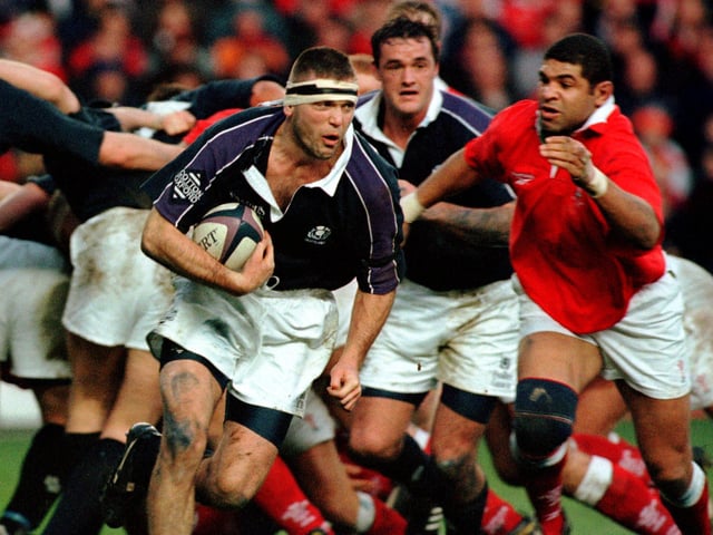 Scotland's Eric Peters, backed by flanker Martin Leslie, charges through the Welsh defence in 1999. Scotland went on to win the final Five Nations rugby championship before the competition was rebranded as the Six Nations in 2000.