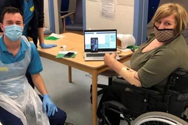 Tech experts helping Marguerite Henderson fit her new bionic 'Michelangelo hand' over Zoom (Photo: NHS Greater Glasgow and Clyde).