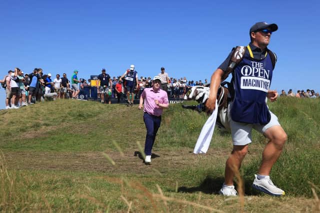 Bob MacIntyre runs to catch up with caddie Mike Thomson after teeing off at the third hole in the third round of the 149th Open at Royal St George’s. Picture: Andrew Redington/Getty Images.