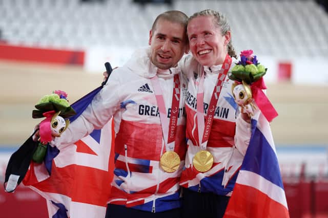 Husband and wife Neil and Lora Fachie celebrate their gold medals at the Tokyo Paralympics. (Photo by Kiyoshi Ota/Getty Images)