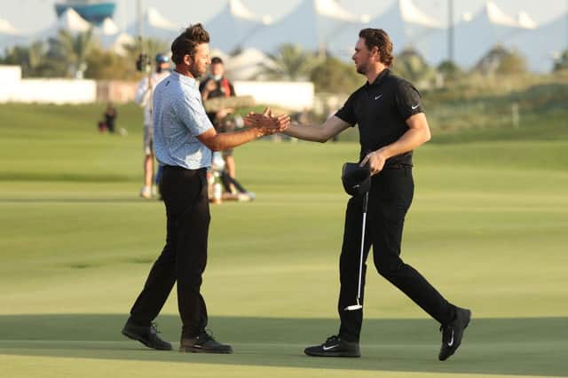 Scott Jamieson, left, congratulates Thomas Pieters on his win in the Abu Dhabi HSBC Championship at Yas Links. Picture: Warren Little/Getty Images.