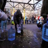 Local residents wait in line to collect water from a public water pump in a park of Kyiv. Picture: AFP via Getty Images