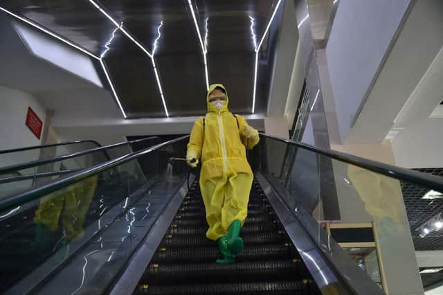 An employee sprays disinfectant as part of preventative measures against the Covid-19 coronavirus at the Pyongyang Children's Department Store in Pyongyang last month.