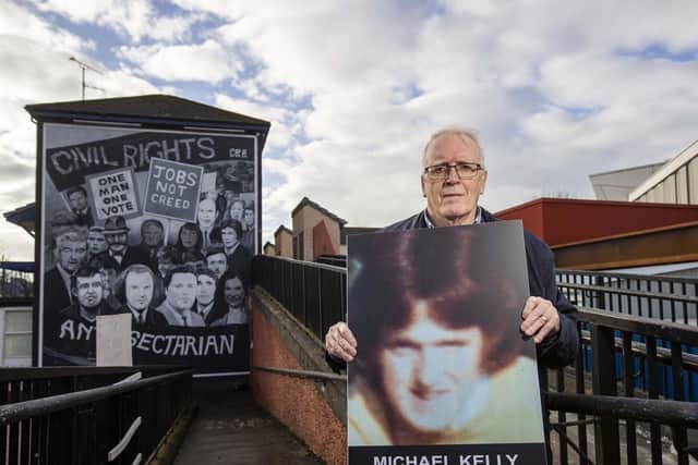 John Kelly, brother of Michael Kelly, who was killed on Bloody Sunday in Derry's Bogside in 1972, holds an image of his brother beside the Civil Rights mural in the city. The campaigner has told how he narrowly avoided being shot on the same day his teenage brother was killed. Photo: Liam McBurney/PA Wire