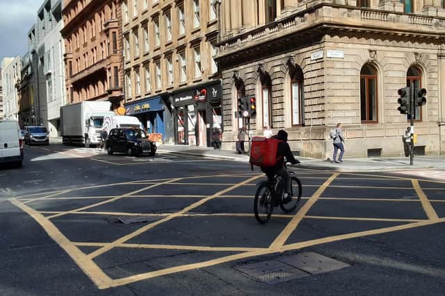 A delivery rider running a red light in Glasgow. Picture: The Scotsman