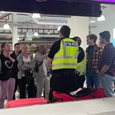 Police were seen at Edinburgh Airport's baggage reclaim area trying to manage the situation.