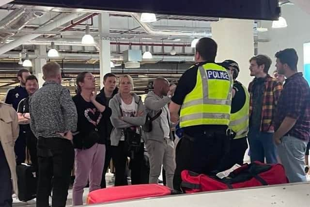 Police were seen at Edinburgh Airport's baggage reclaim area trying to manage the situation.