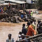 Residents of Mathare, Nairobi, stand next to houses destroyed by storms and flash floods last month (Picture: Simon Maina/AFP via Getty Images)