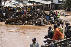Residents of Mathare, Nairobi, stand next to houses destroyed by storms and flash floods last month (Picture: Simon Maina/AFP via Getty Images)