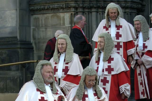 Judges in their red robes leave St Giles' Cathedral in Edinburgh after a Kirking of the Court ceremony