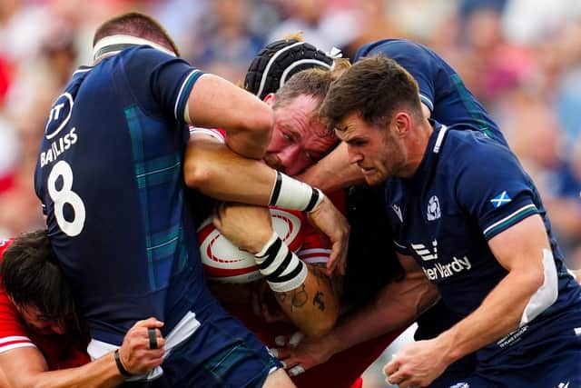 Scotland's Josh Bayliss, left, and Matt Currie, right, try to dislodge the ball from Canada's Conor Keys during the first half in Ottawa. (Photo by Canadian Press/Shutterstock)
